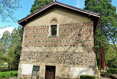 Boyana Church exterior with stone walls and pointed roof under clear blue sky