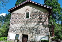 Exterior view of Boyana Church surrounded by trees
