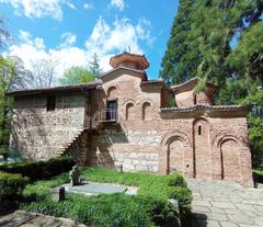 Exterior view of Boyana Church surrounded by autumn foliage