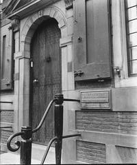 Black and white photograph of a street in Amsterdam showing typical Amsterdam landmarks and architecture in 1945 after World War II