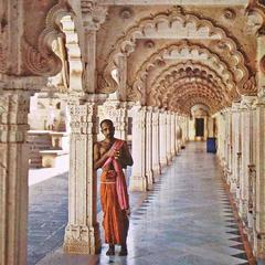 Jain priest in orange dhoti and bare torso inside Hathi Singh temple Ahmedabad 1913