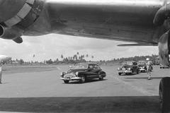 Convoy of cars leaving Kemajoraan Airport in Batavia, Indonesia during General H.J. Kruls' inspection tour in 1947