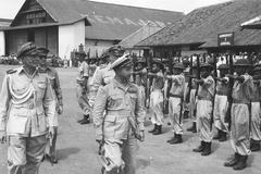 Brigadier-General Bodet arriving in Batavia on a C-47 Dakota aircraft inspecting the honor guard on May 31, 1948
