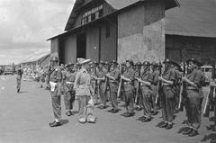 General H.J. Kruls inspecting the honor guard at Kemajoraan airport upon arrival in Batavia, Indonesia, May 1, 1947