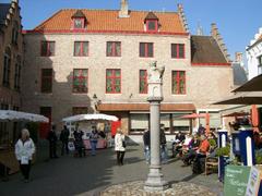 Huidensvettersplein square in Bruges with historical buildings and outdoor cafes
