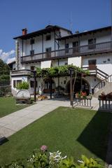 Exterior of Osteria alla Buona Vite with original 1929 fountain and century-old pergola