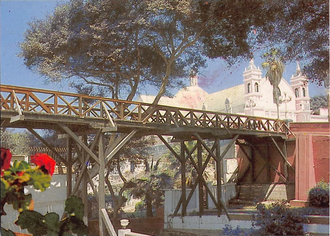Underside view of the Puente de los Suspiros bridge in Barranco with La Bajada de Baños street and the Hermita chapel