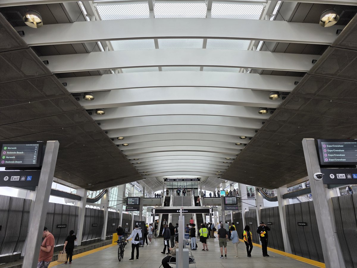 Platform at LAX Metro Transit Center on opening day with passengers and signage