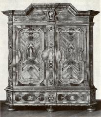 Antique wooden Frankfurter Schrank cabinet with ornate carvings and intricate metal hardware
