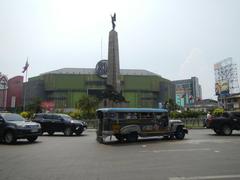 Aerial view of Monumento Roundabout featuring the Andrés Bonifacio National Monument in Caloocan City at the intersection of major roads including EDSA and Rizal Avenue