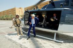 U.S. Secretary of State John Kerry buttoning jacket after stepping off helicopter in Baghdad