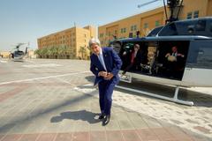U.S. Secretary of State John Kerry buttoning jacket after helicopter landing in Baghdad