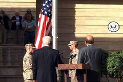 U.S. Ambassador John D. Negroponte and U.S. Marines raising the American flag at the new U.S. Embassy in Iraq