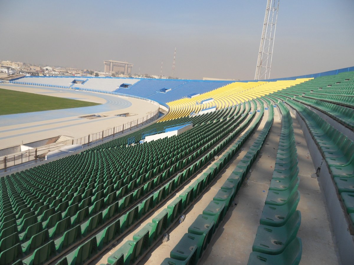 Al-Shaab Stadium aerial view with football field and seating areas