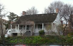 Historic Dyckman House farmhouse seen from Broadway on a cloudy midday