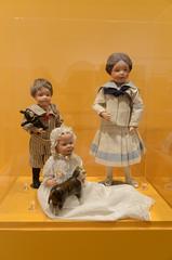 Vintage Schoenhut dolls including Boy Doll, Carved Hair Girl, and Infant Doll from Philadelphia History Museum exhibit