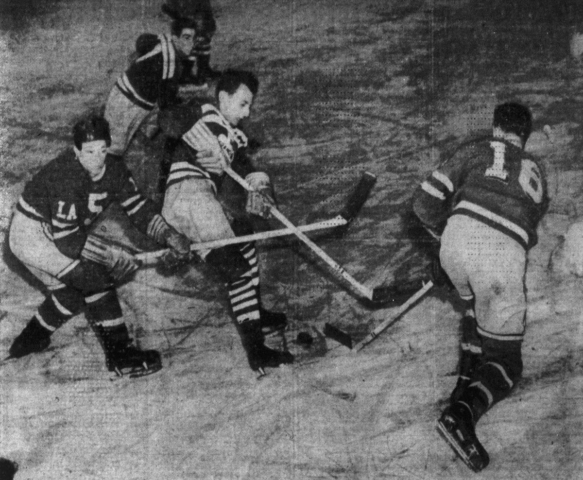 San Francisco Shamrocks ice hockey player battles Los Angeles Monarchs players for puck during 1946 game