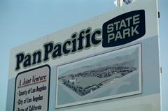 Pan Pacific State Park sign on a wooden post surrounded by green trees