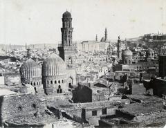 Panorama of Cairo city featuring numerous minarets and mosques with the Citadel boundary wall and Bab al-Azab entrance in the background