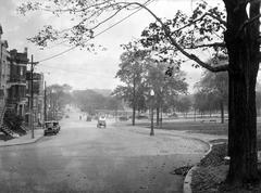 Historic Avenue du Mont-Royal Ouest looking east from chemin de la Côte-Sainte-Catherine circa 1930 with tramway, park avenue, and police officer managing morning traffic