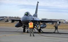 Tech. Sgt. Devin Richters and Tech. Sgt. Jonathan Kruse monitoring F-16 Fighting Falcon during hot pit refueling at Joe Foss Field