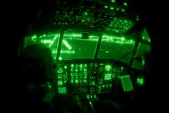 Capt. Andrew Reinhart and Lt. Col. Anthony Determan using night vision goggles to guide aircraft landing at Sioux Falls Airport