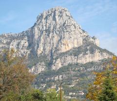 Baou de Saint-Jeannet rocky ridge with lush green vegetation under clear sky