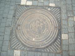 Manhole cover with Tel Aviv Harbor symbol at Tel Aviv Harbor
