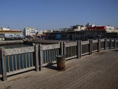 Panoramic view of Tel Aviv harbor with boats and city skyline at sunset