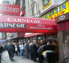 Customers lined up outside Carnegie Deli on a cloudy midday