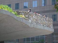 Southeast corner of Irish Hunger Memorial with ledge extending over structure and view of Hudson River in Battery Park City, Manhattan
