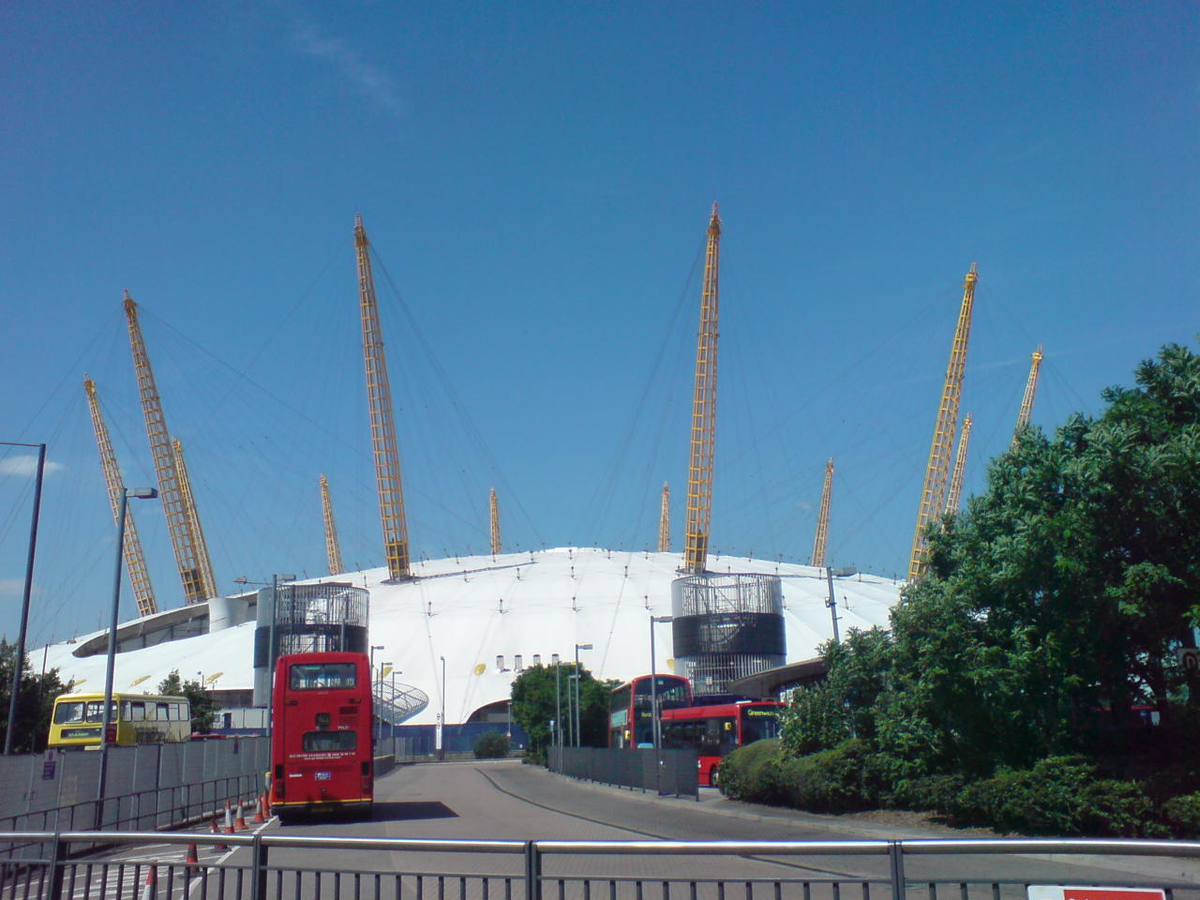 O2 Center Millennium Dome in London at dusk with illuminated exterior and surrounding cityscape