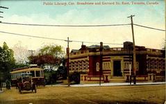 Toronto Public Library at the corner of Broadview Avenue and Gerrard Street East with a streetcar on Gerrard Street going west