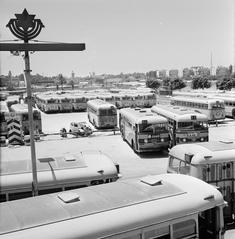 Vintage black and white photo of buses parked at a Tel Aviv bus depot on the Sabbath in 1964