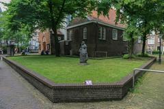 Beginenhof courtyard in Amsterdam with historic brick buildings and greenery
