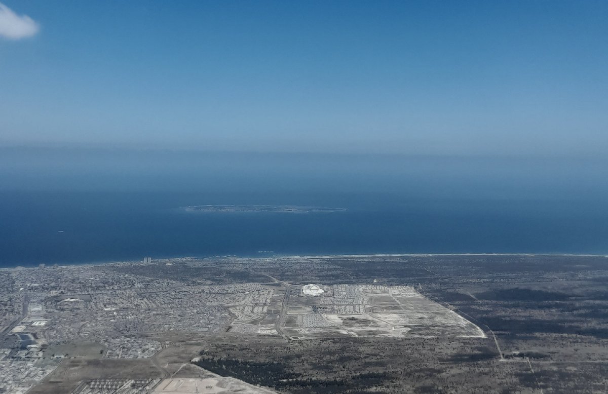 Aerial view of Robben Island and Bloubergstrand coastline with clear blue waters