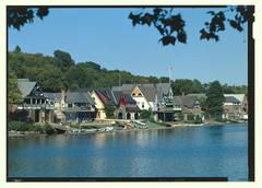Boathouse Row historic buildings along East River Drive in Philadelphia with colorful boathouses reflected in the water at sunset