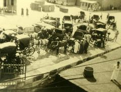 Historic carriages lined up on the dock at Jaffa Port with the sea in the background