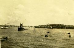 Ships and boats docked at Jaffa Port with cityscape in the background