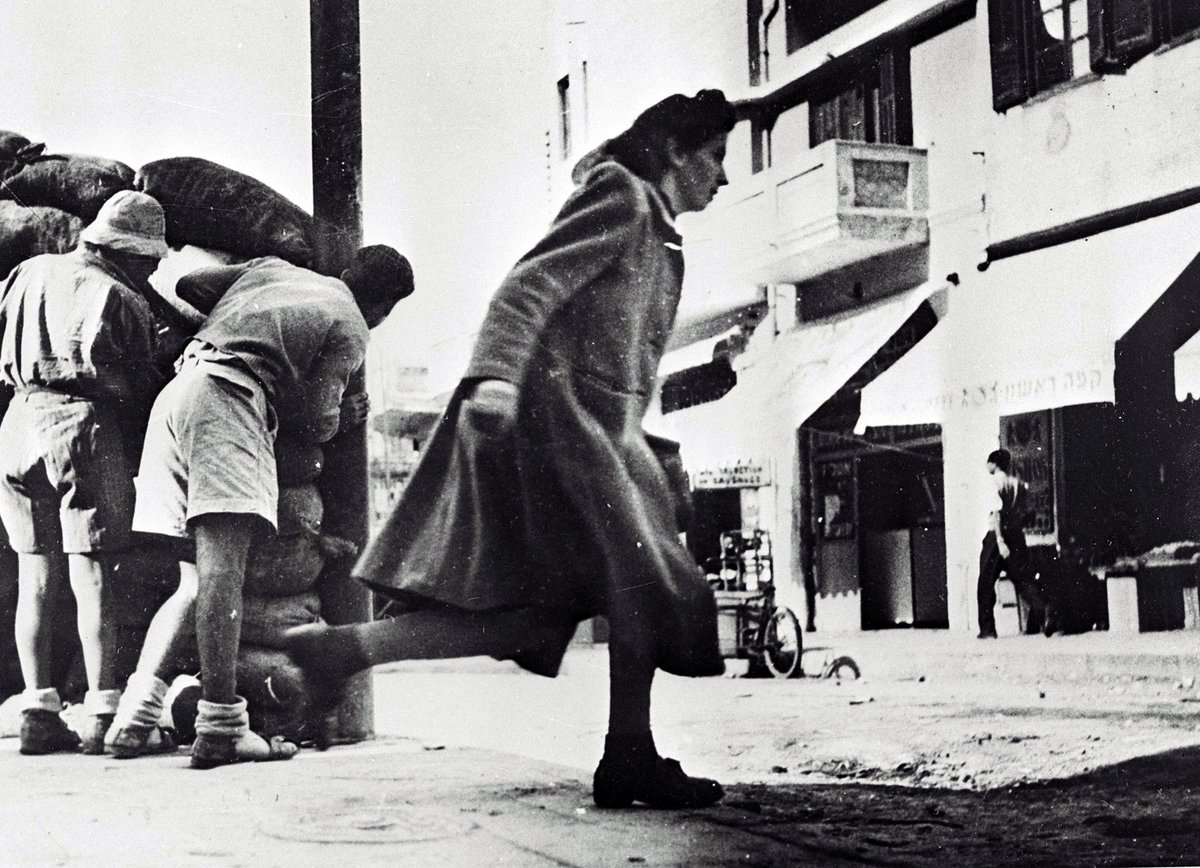Residents running from sniper fire near Hassan Bek Mosque in Jaffa, Tel Aviv