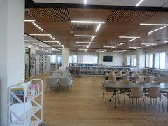 Migdal Shalom Library interior with modern bookshelves and reading areas