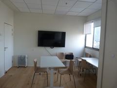 Migdal Shalom Library interior with bookshelves and seating areas