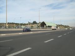 University train station platform with tracks and surrounding buildings