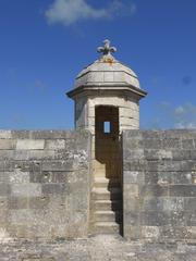 Stone sentry box with fleur de lys atop overlooking firing platform at Fort Louvois
