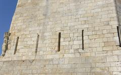 Bourcefranc Fort Louvois donjon with royal coat of arms carved above five archers' loopholes under a cloudy sky