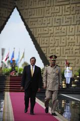 U.S. Defense Secretary Leon E. Panetta and Egyptian Maj. Gen. Rouini laying wreaths at the Tomb of the Unknown Soldier and President Anwar Sadat's memorial in Cairo