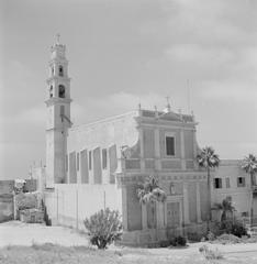 Sint Pieterskerk church with bell tower in Jaffa, Tel Aviv, Israel, featuring baroque architecture, crosses, palm trees, and tower bells