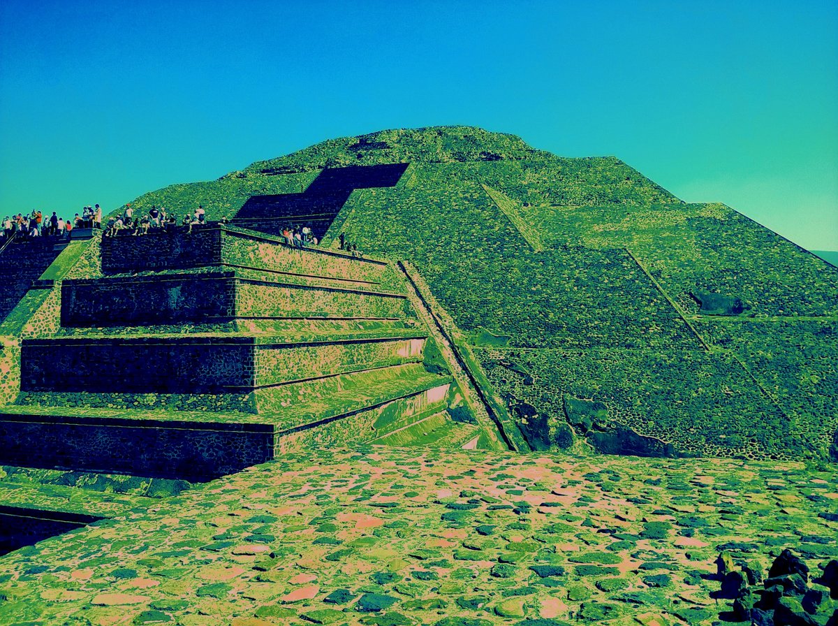 Aerial view of the ancient city of Teotihuacán showing the Pyramid of the Sun and Pyramid of the Moon surrounded by urban landscape