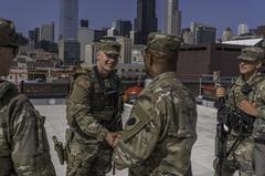 Maj. Gen. Rodney Boyd presenting command coin to Pvt. Leo Roth during Democratic National Convention safety mission