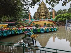 Lush green pathway in Suoi Tien Park in July 2023 under blue sky